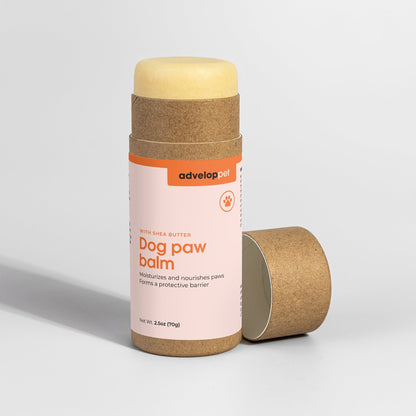 Dog paw balm in a cardboard container on a white background
